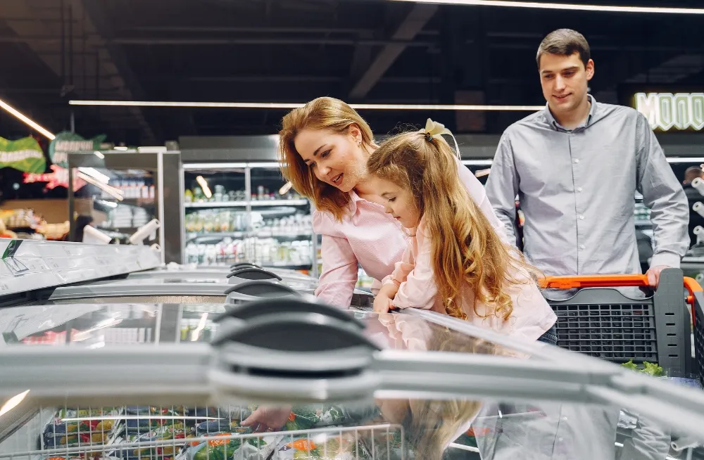 Family inspecting a commercial chiller freezer in Dubai.