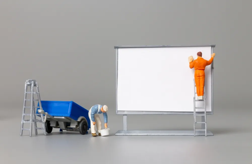 Workers repairing a sign board in Dubai, addressing common issues like LED failures and structural damage